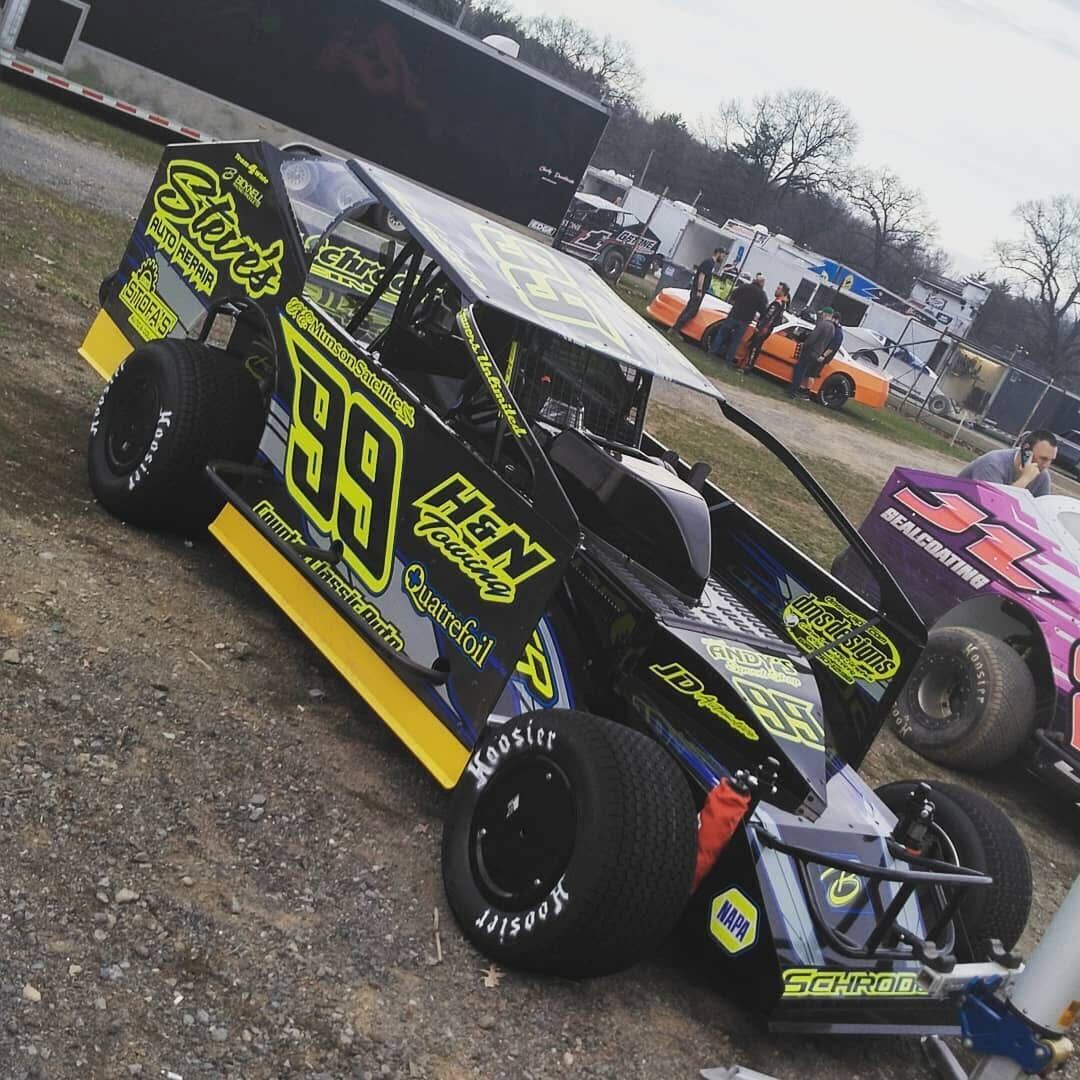 Car #99 dirt modified on the ground with neon green and black H&N Towing livery