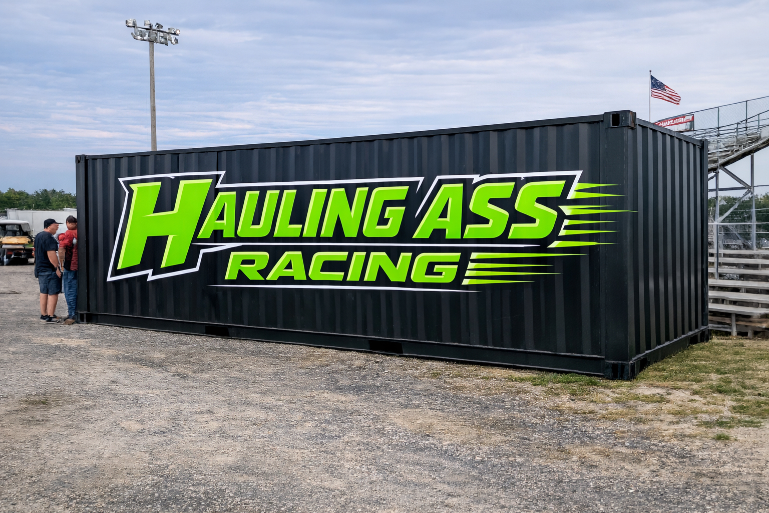 Hauling Ass Racing branded shipping container at the track